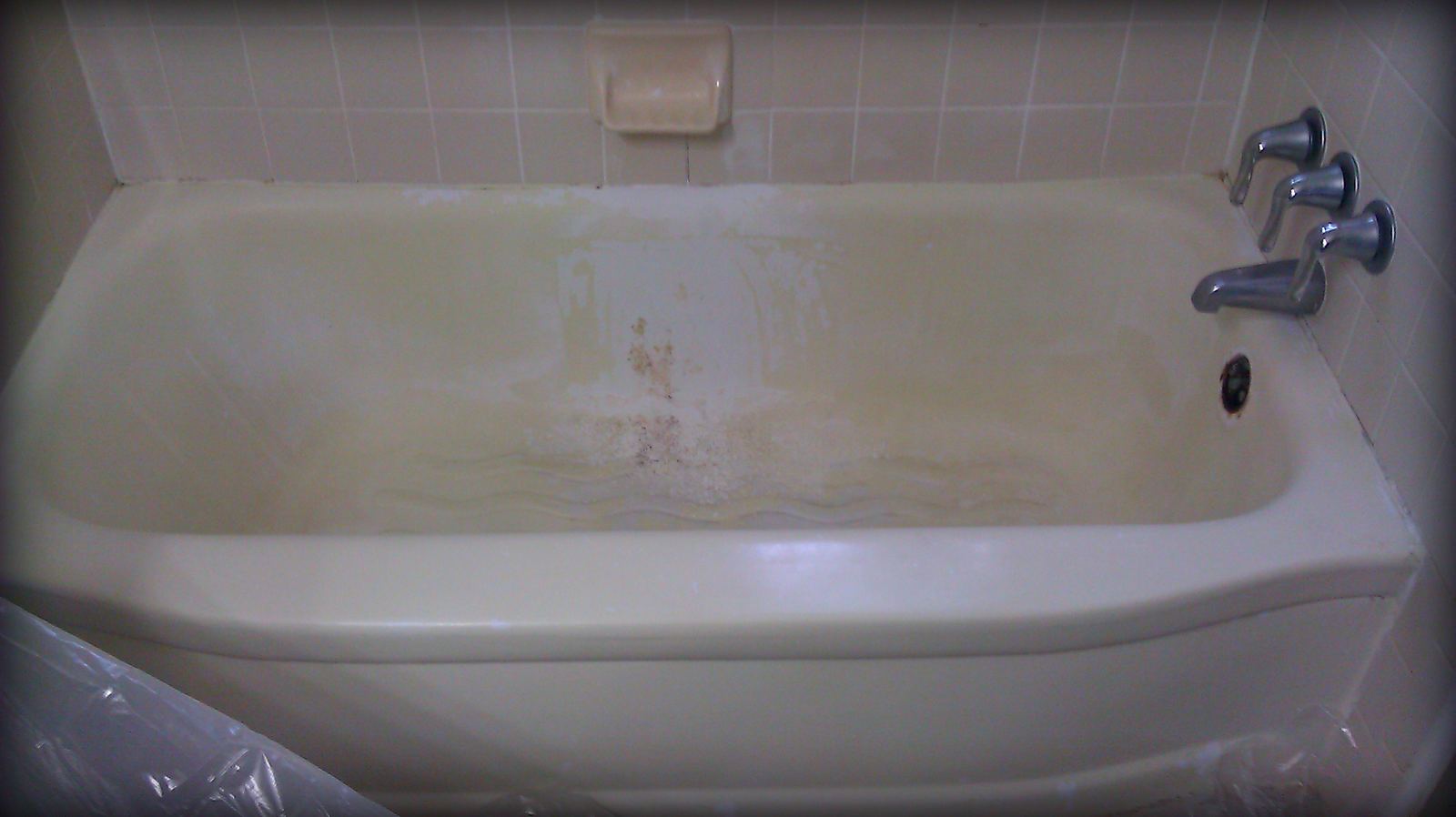Before: aged tub finish prior to liquid liner application